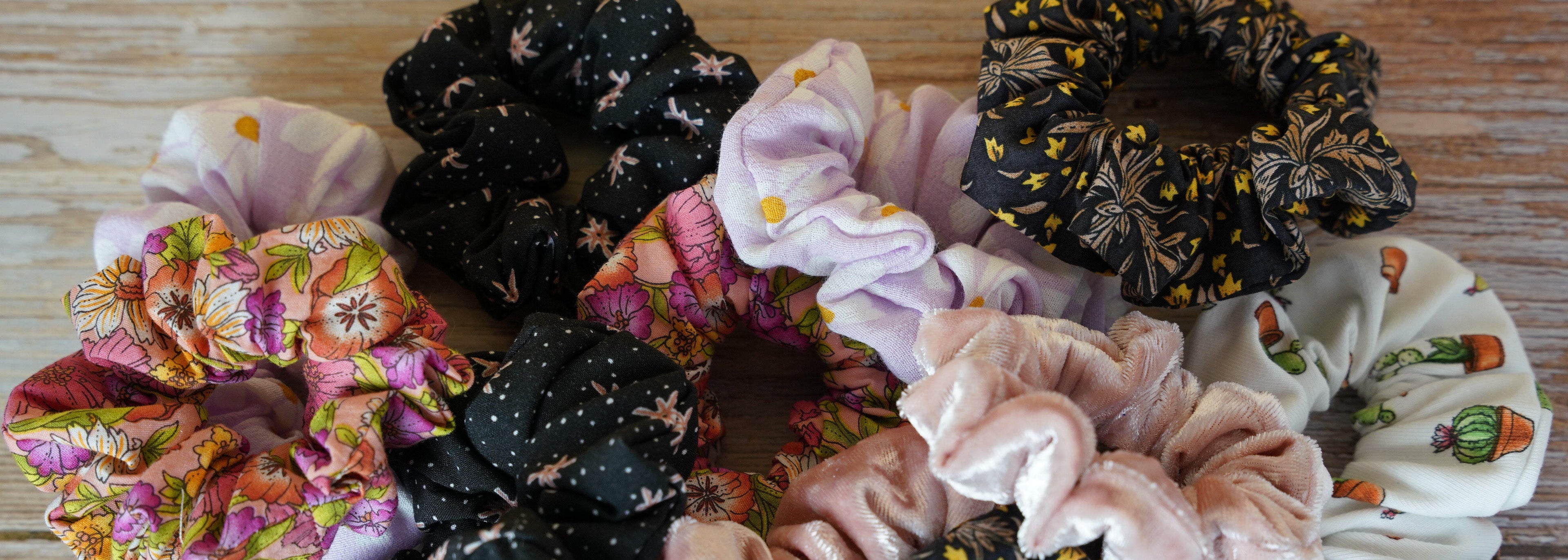 Collection of colorful scrunchies on a wooden surface