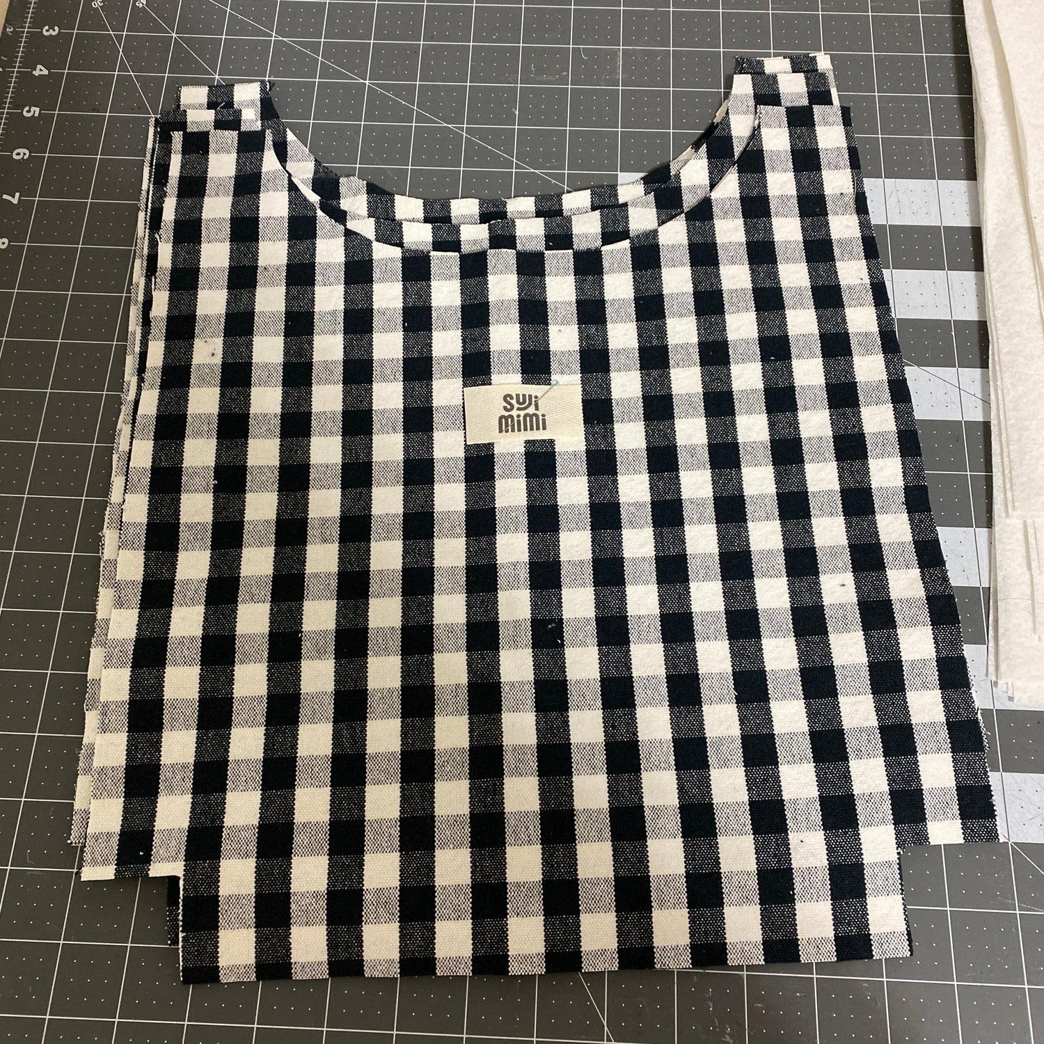 Black and white checkered fabric on a cutting mat